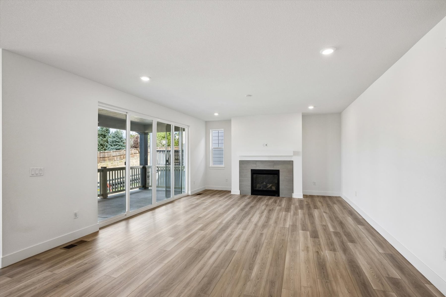 A large white room with a fireplace.