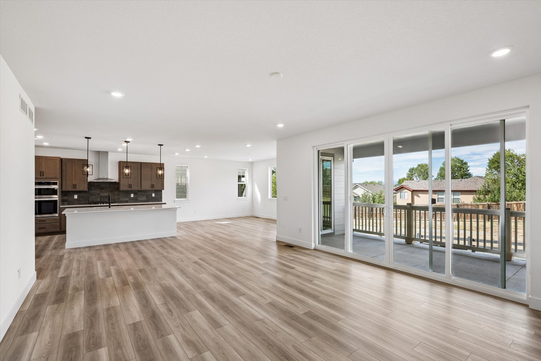A large room with a wood floor and a wood floor.