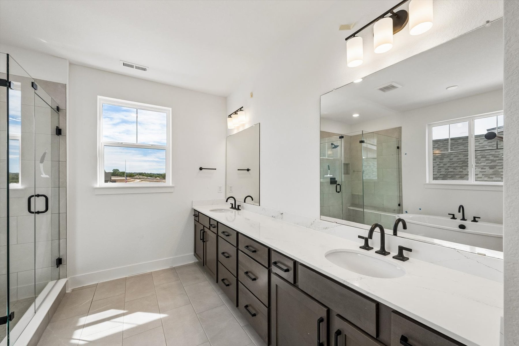 A bathroom with a large mirror.