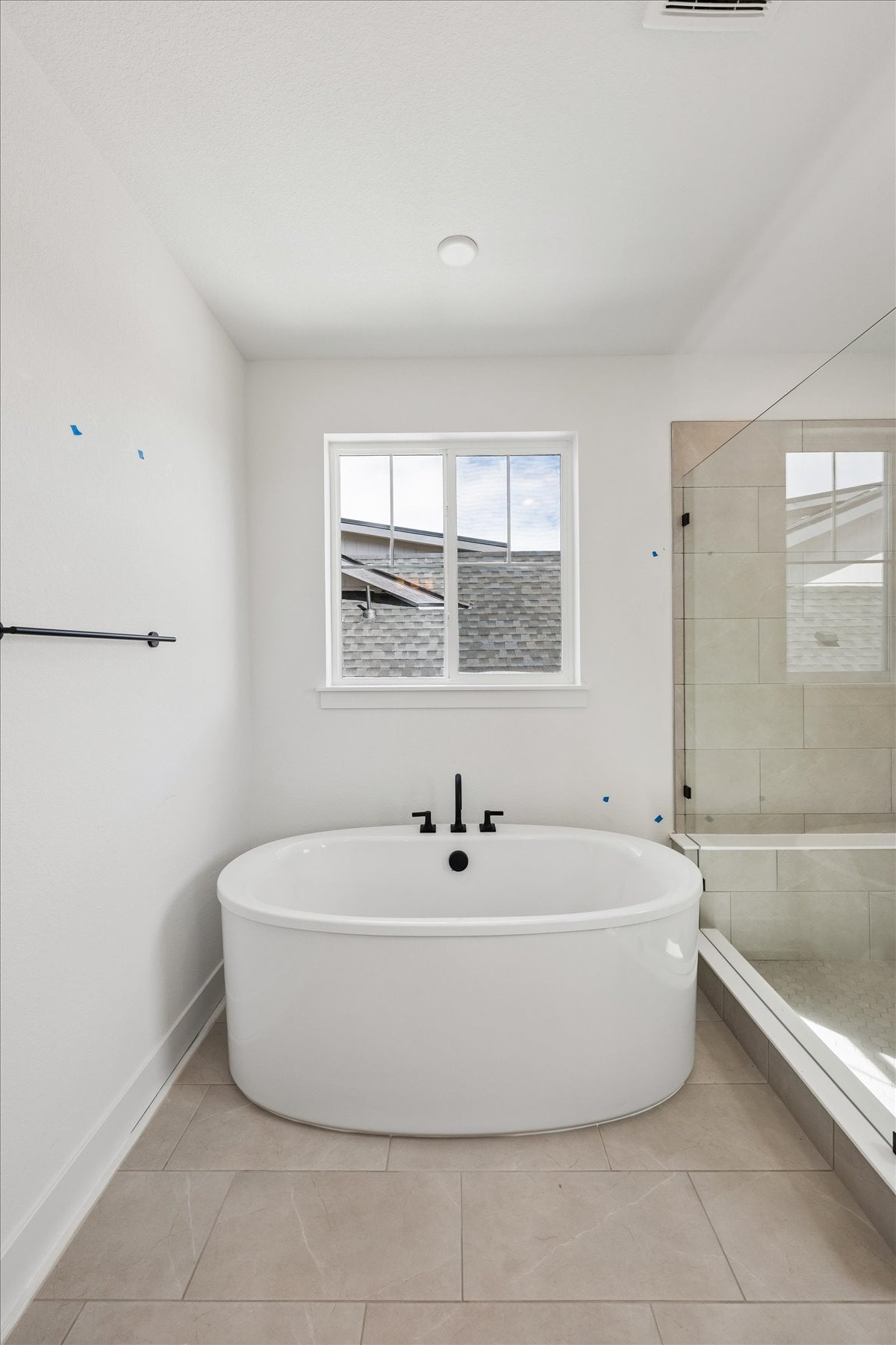 A bathroom with a tub and a window.