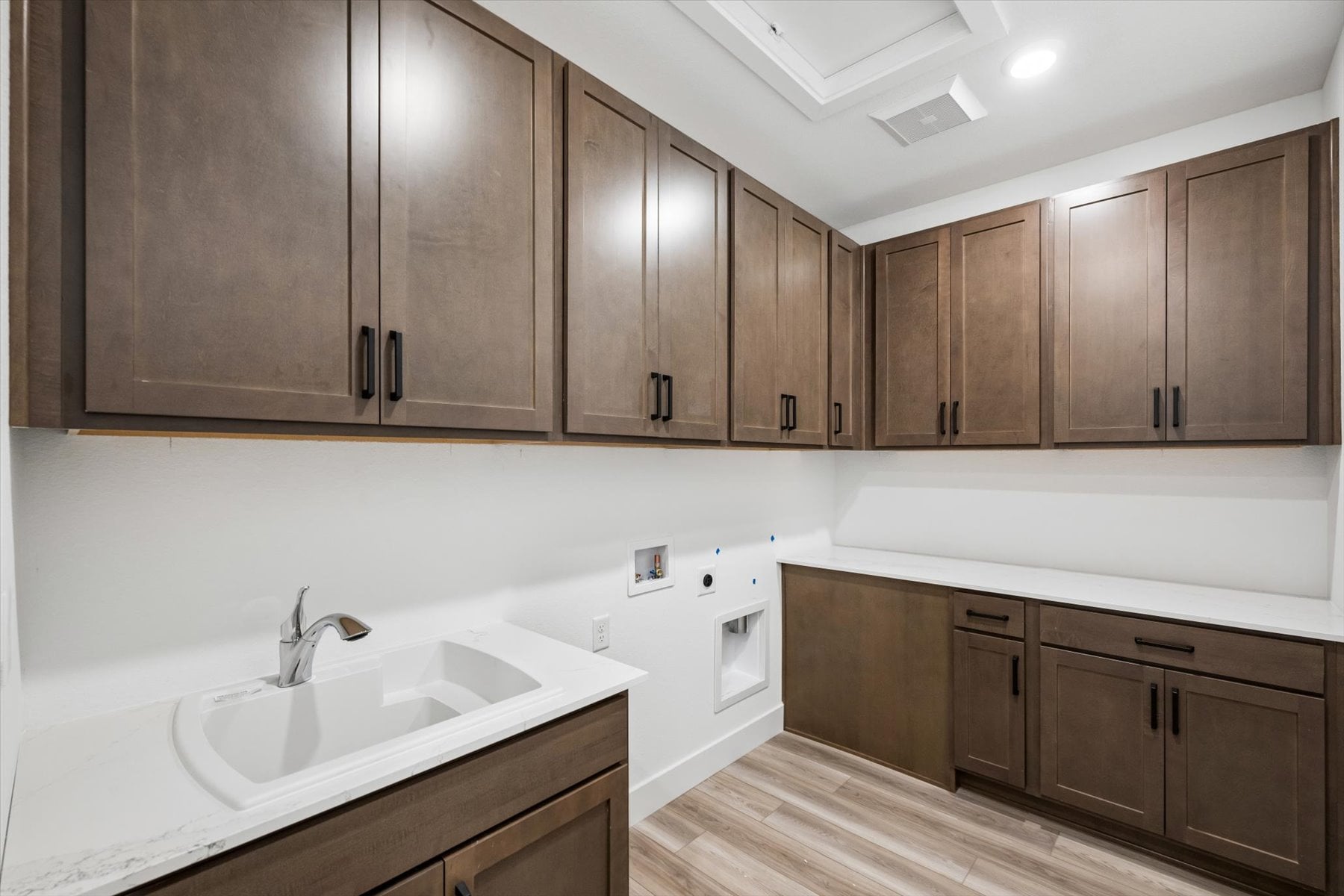 A kitchen with wooden cabinets.