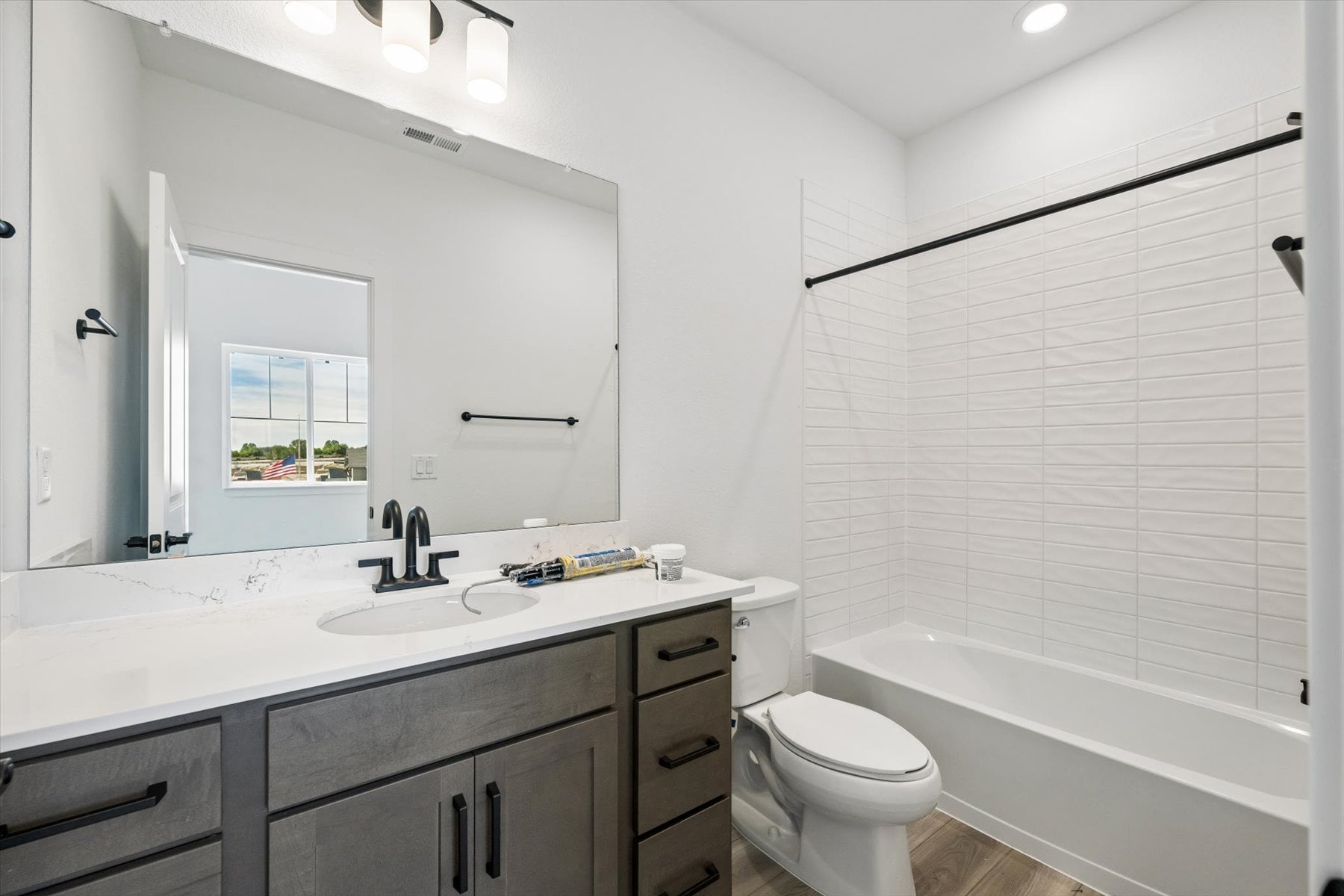 A bathroom with a tub sink and toilet.