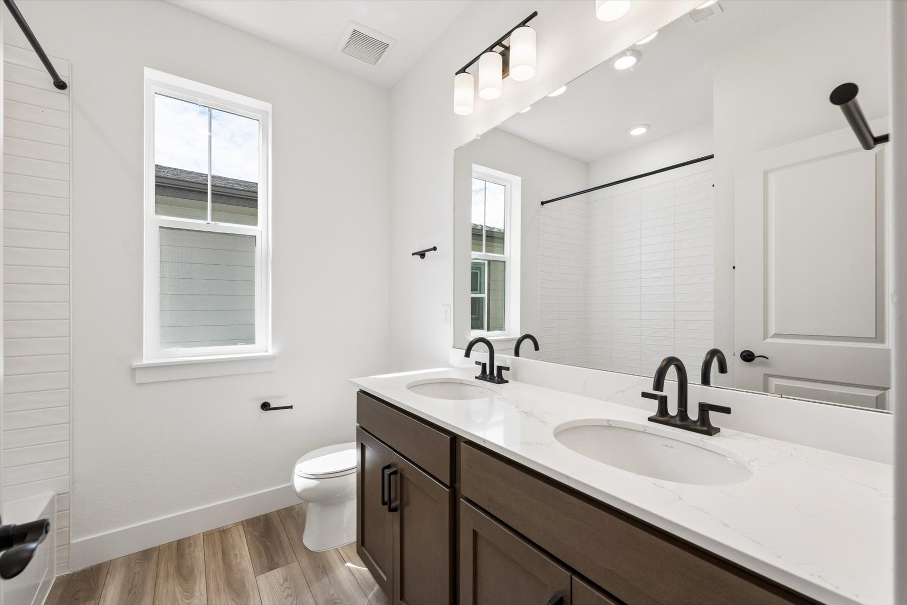 A bathroom with a large mirror.