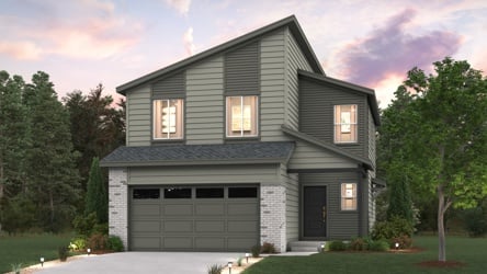 A house with a garage and trees in the back.