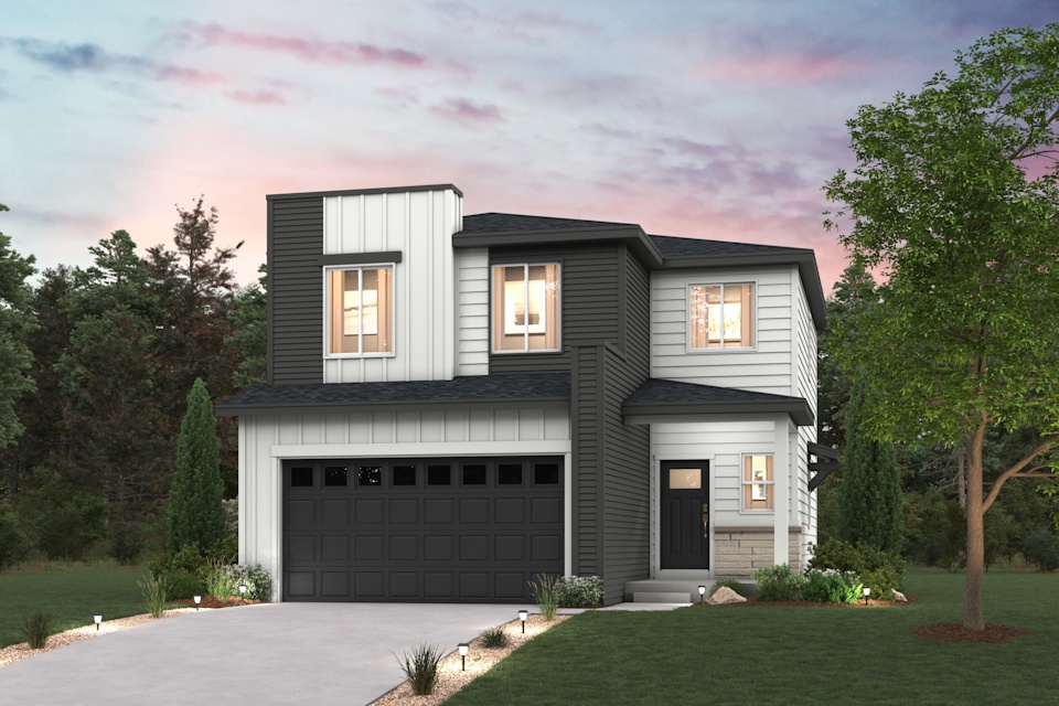 A house with a garage and trees around it.