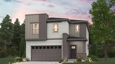 A house with a garage and trees around it.