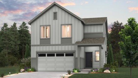 A house with a garage and trees.