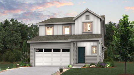 A house with a garage and trees.