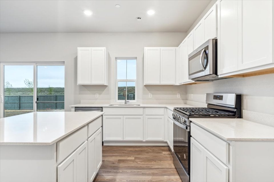 A kitchen with white cabinets.