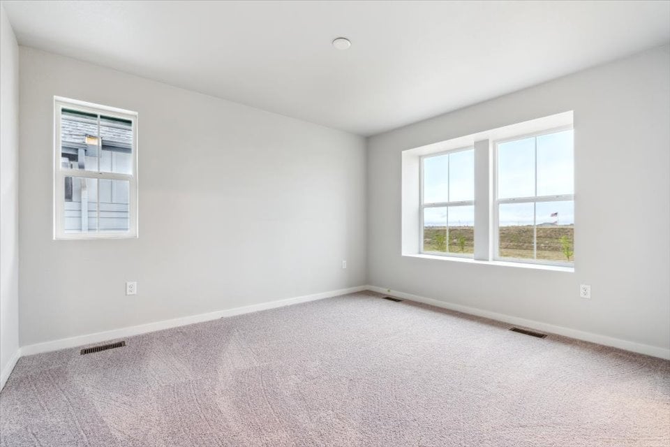 A room with a window and a carpet.