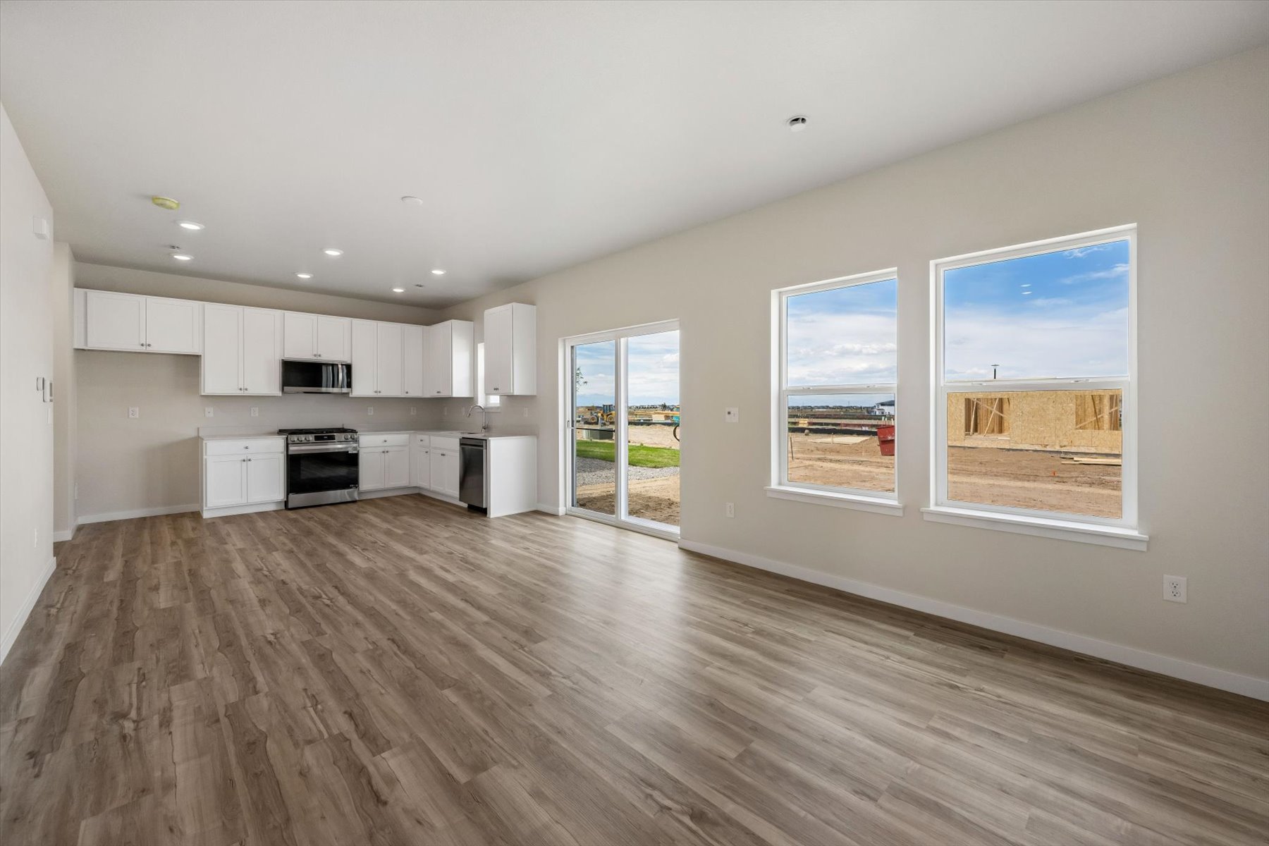 A kitchen with white cabinets.