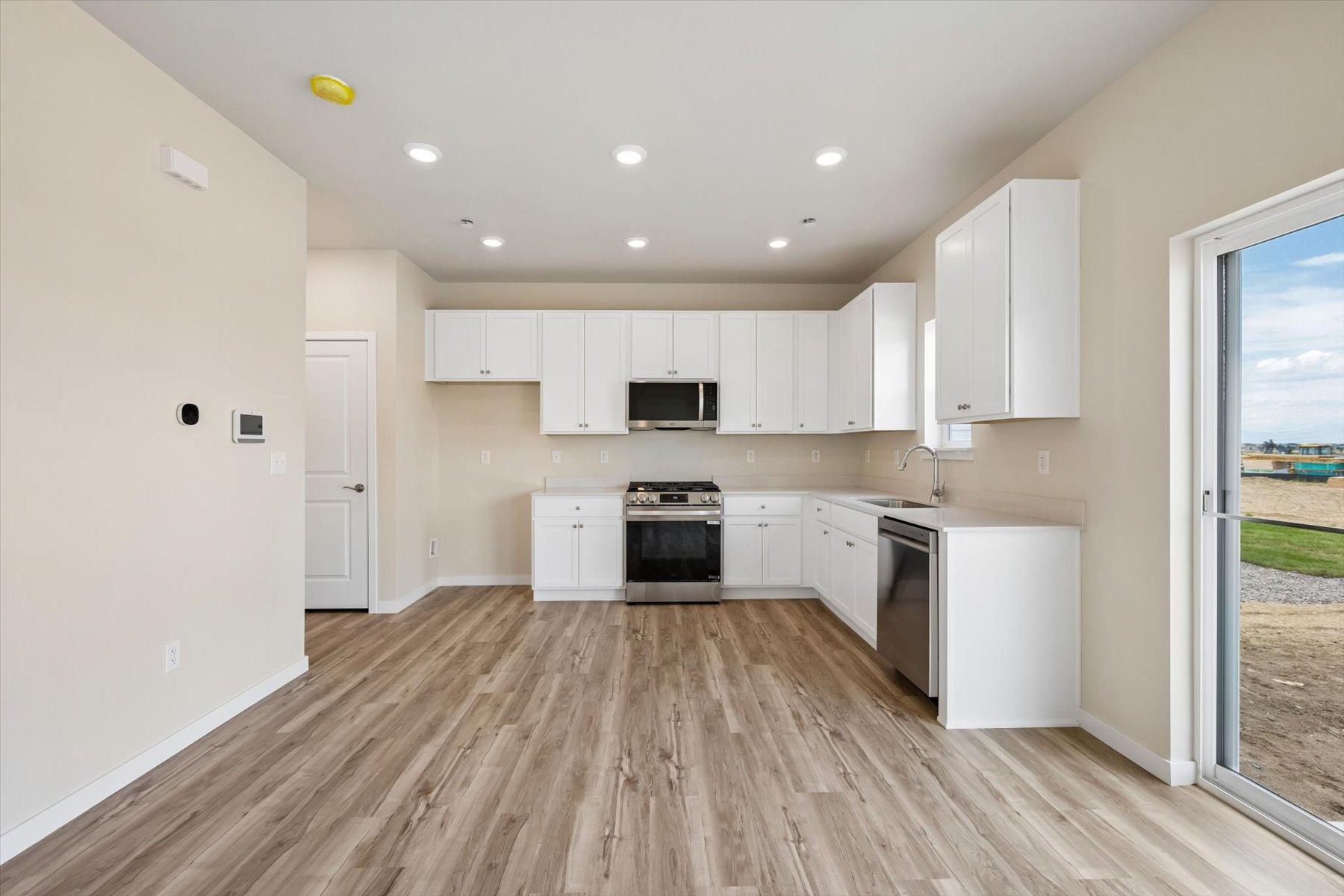A kitchen with white cabinets.