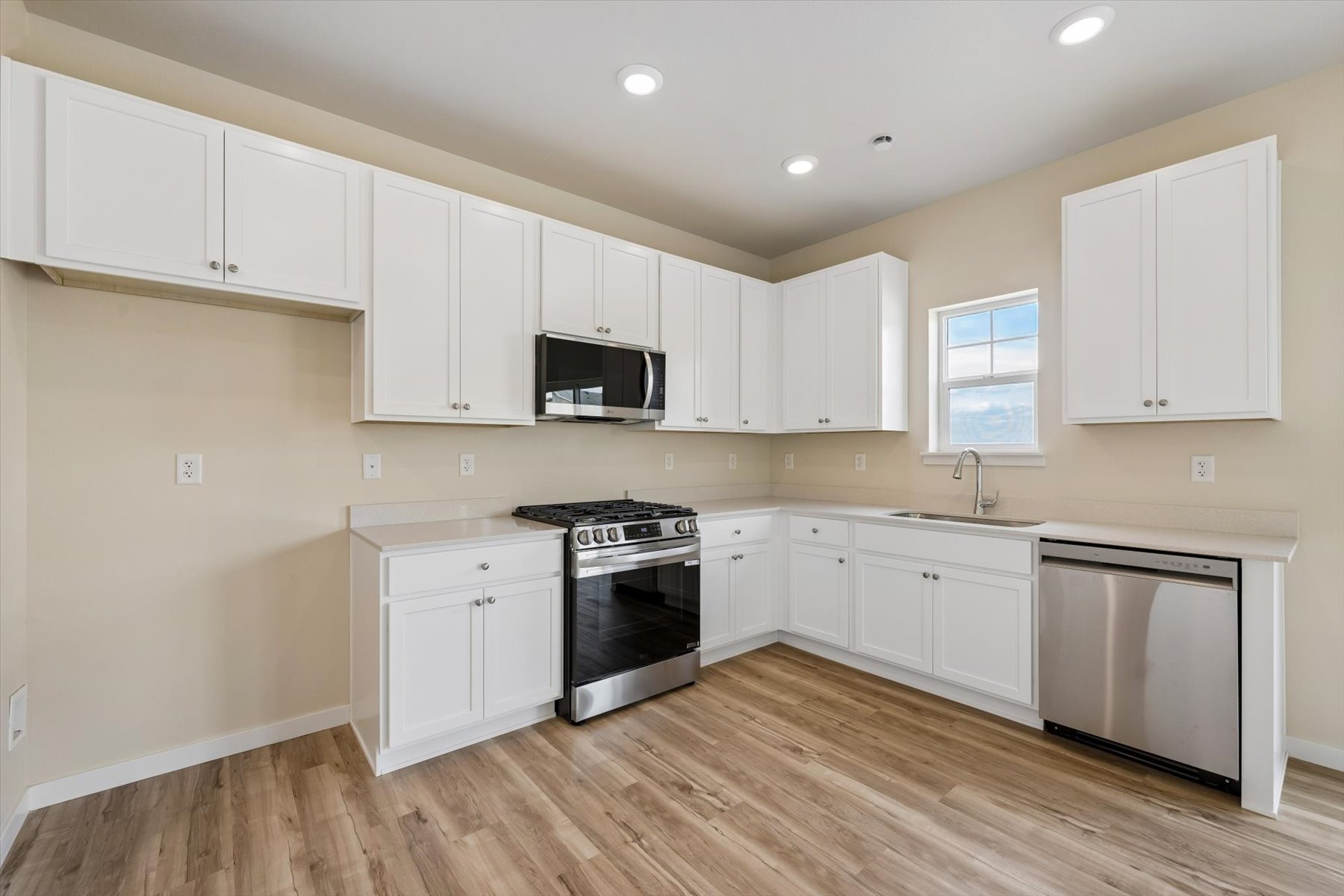 A kitchen with white cabinets.