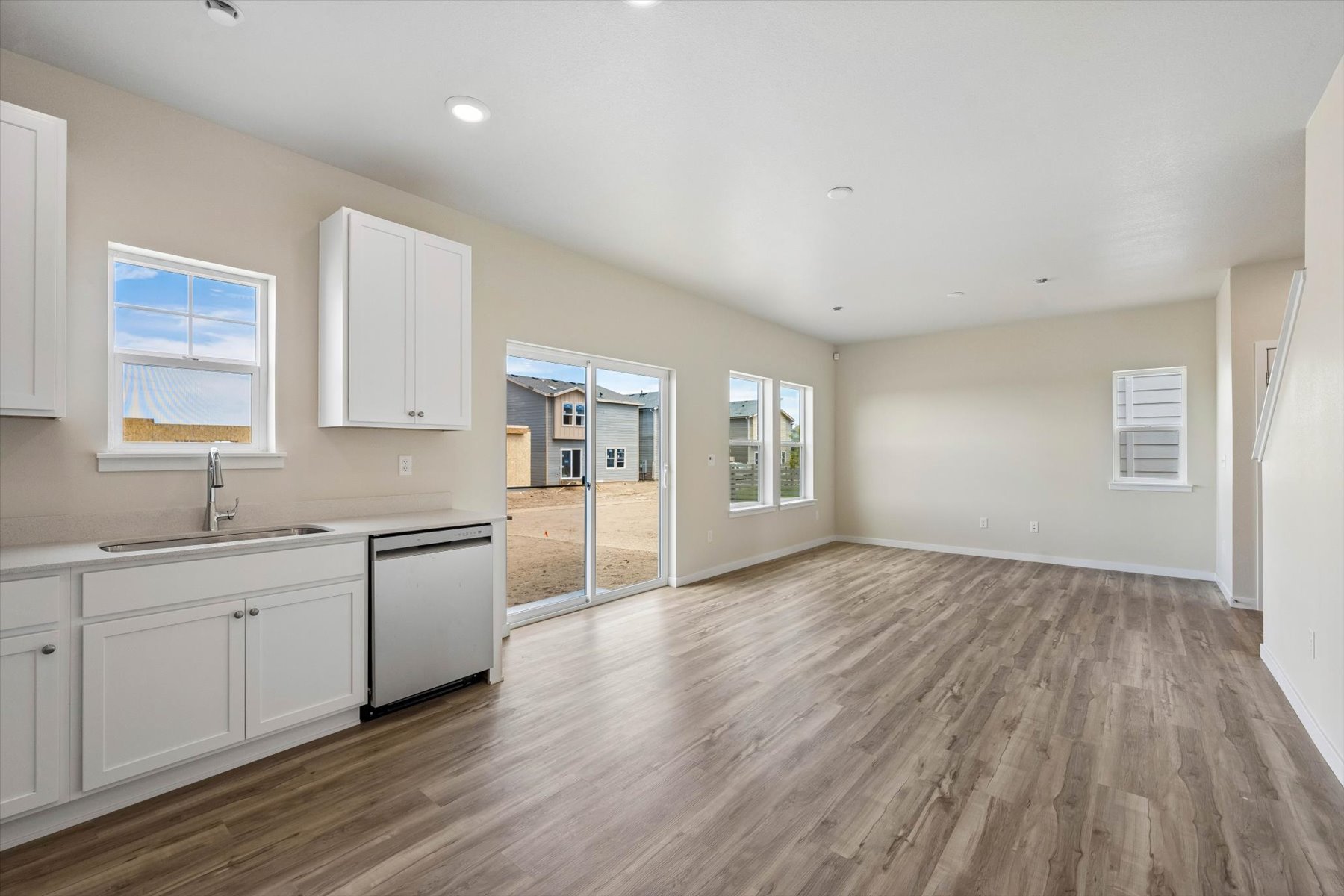 A kitchen with white cabinets.