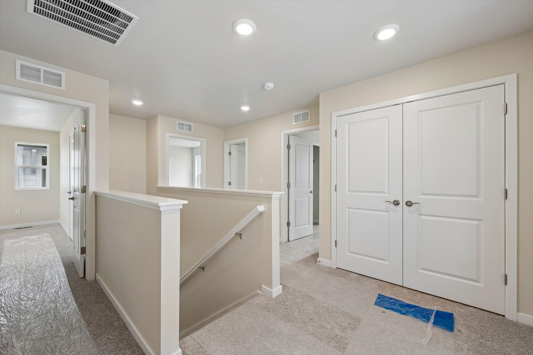 A large bathroom with white cabinets.