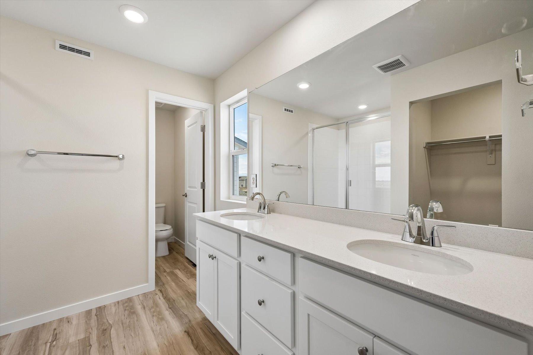 A bathroom with a large mirror.