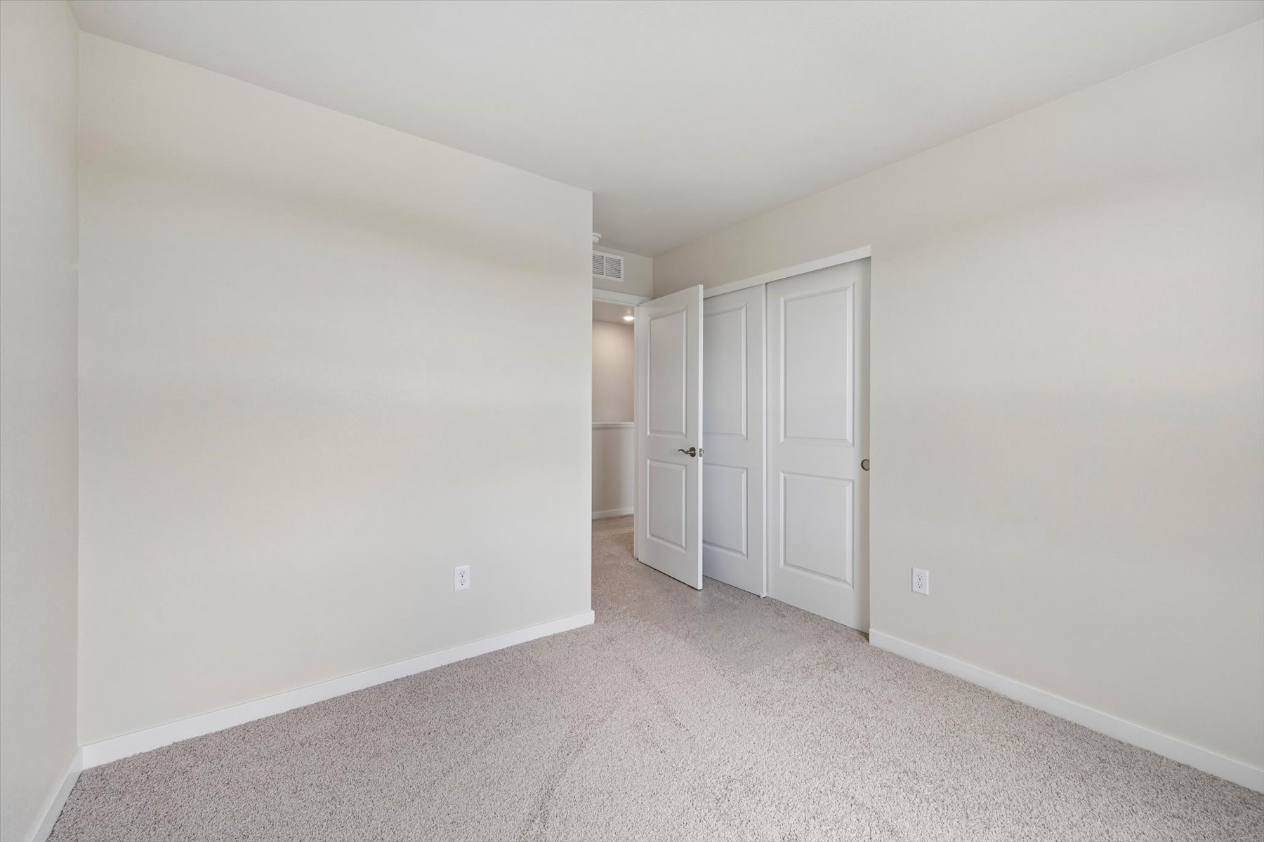 A hallway with white doors.