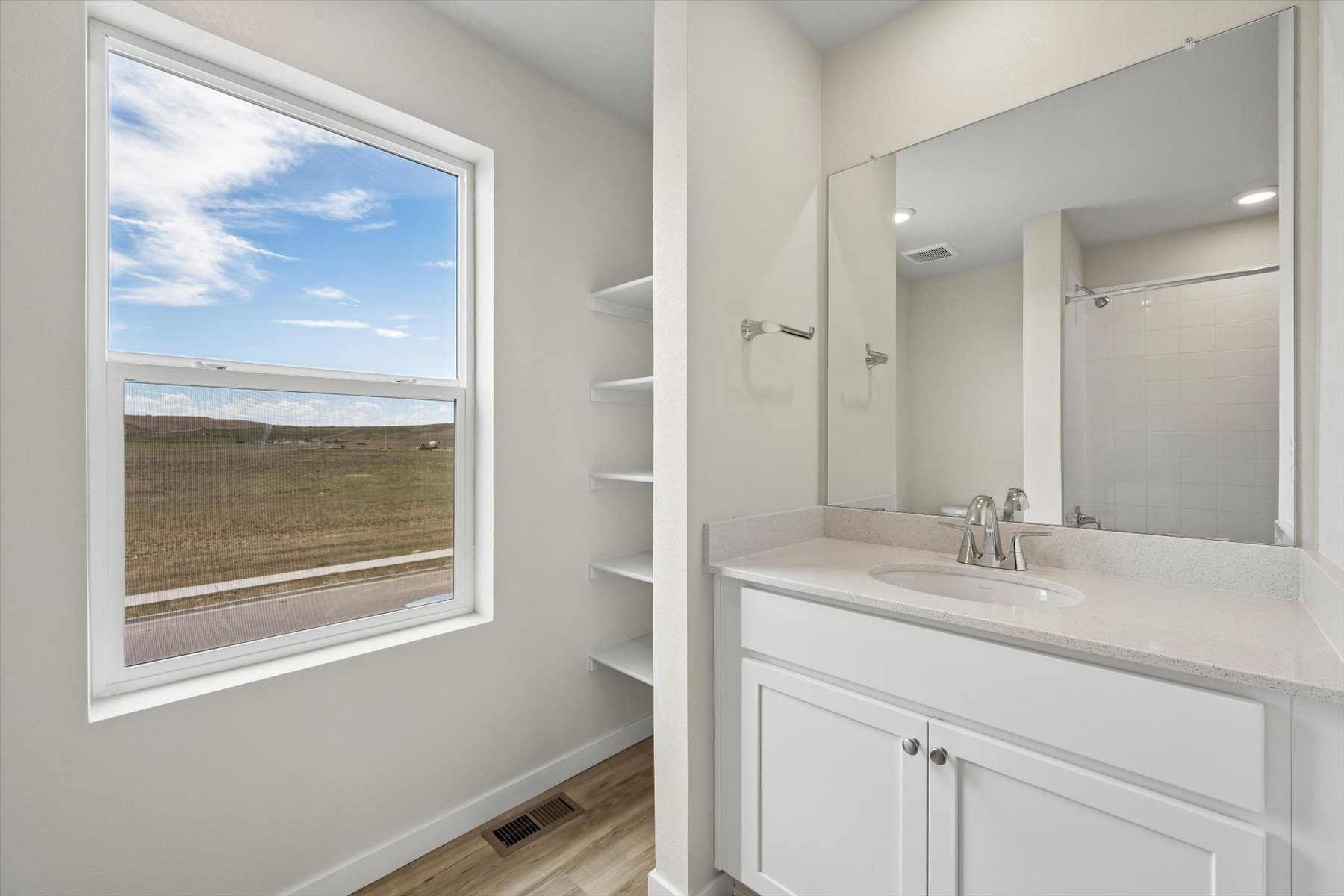A bathroom with a large window.