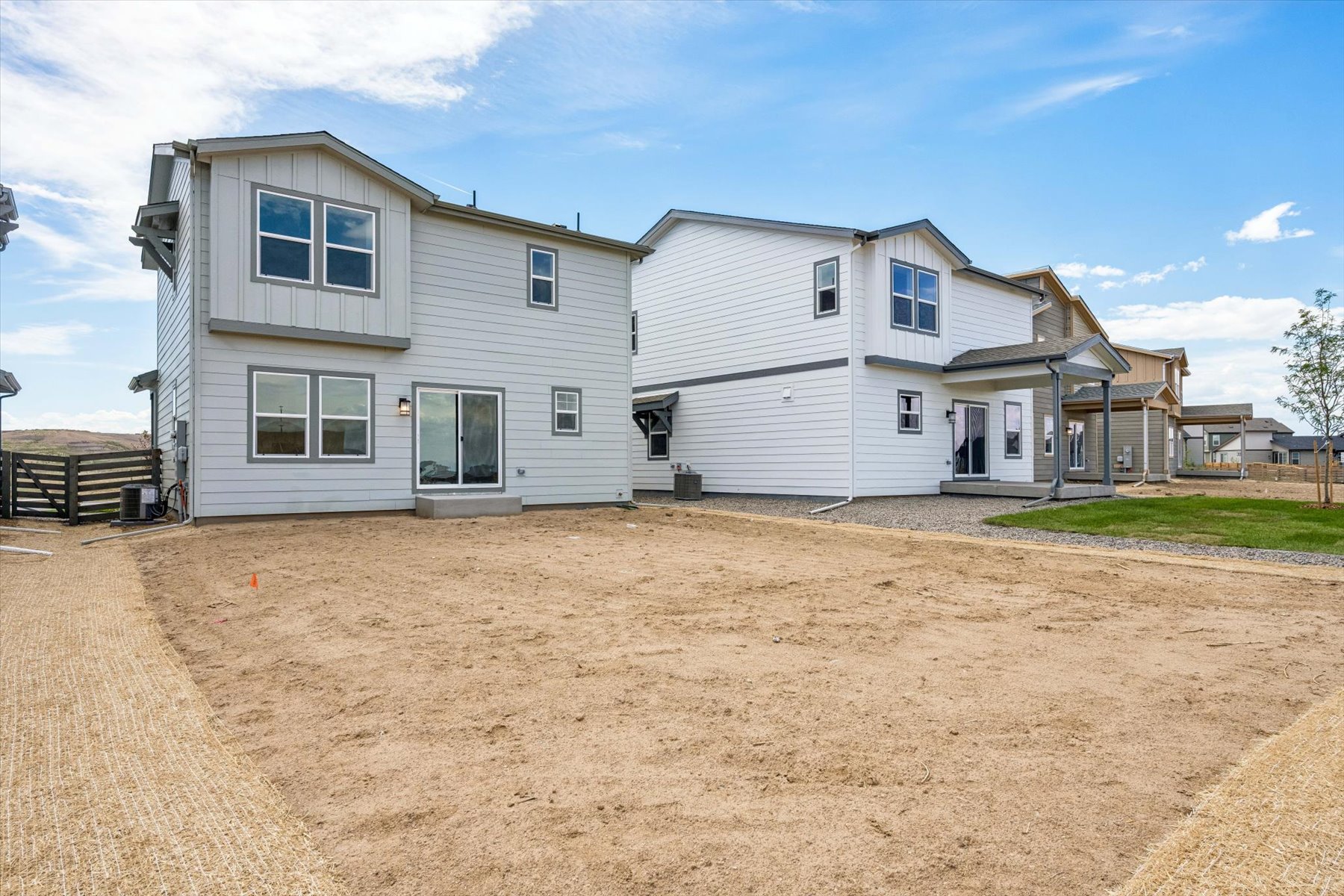 A dirt yard with a house.