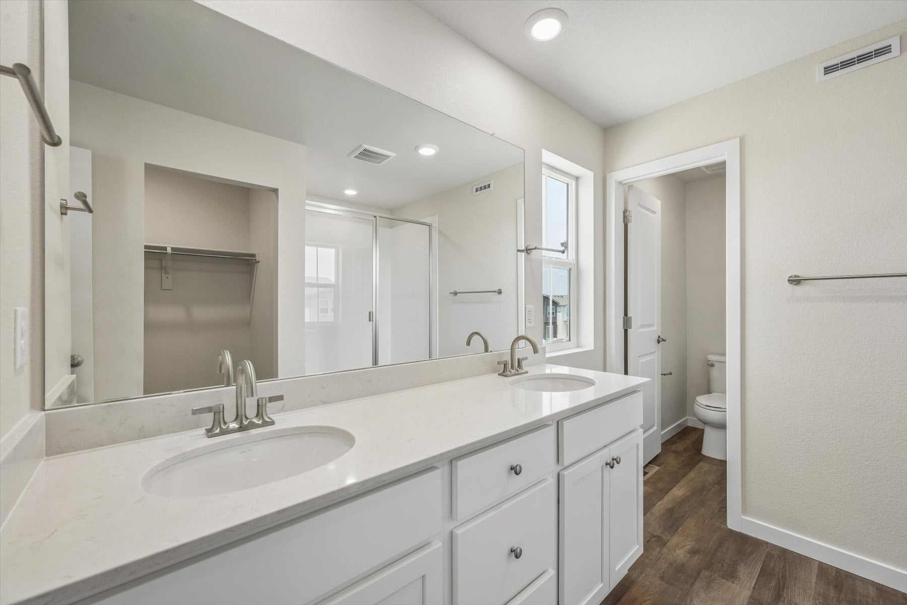 A bathroom with a large mirror.