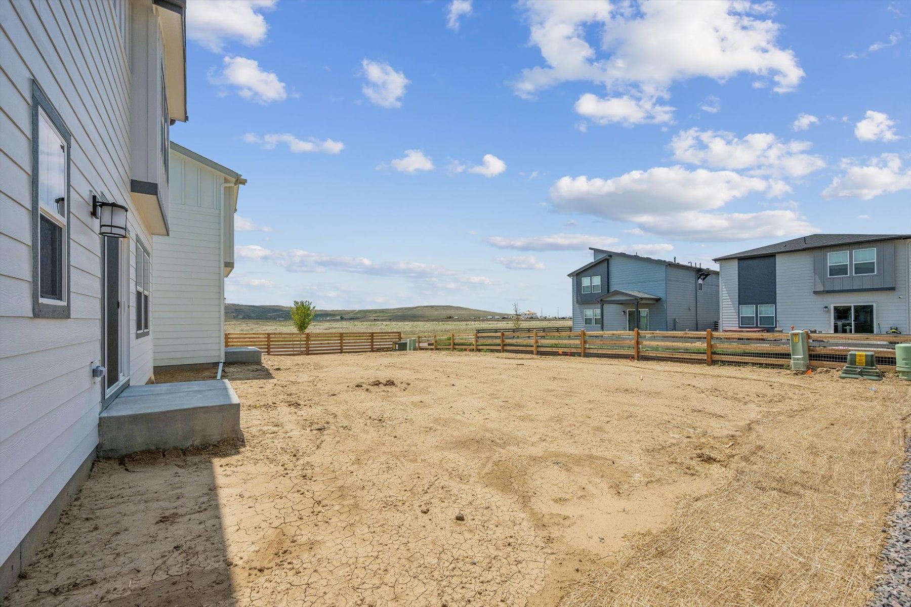 A dirt road between buildings.