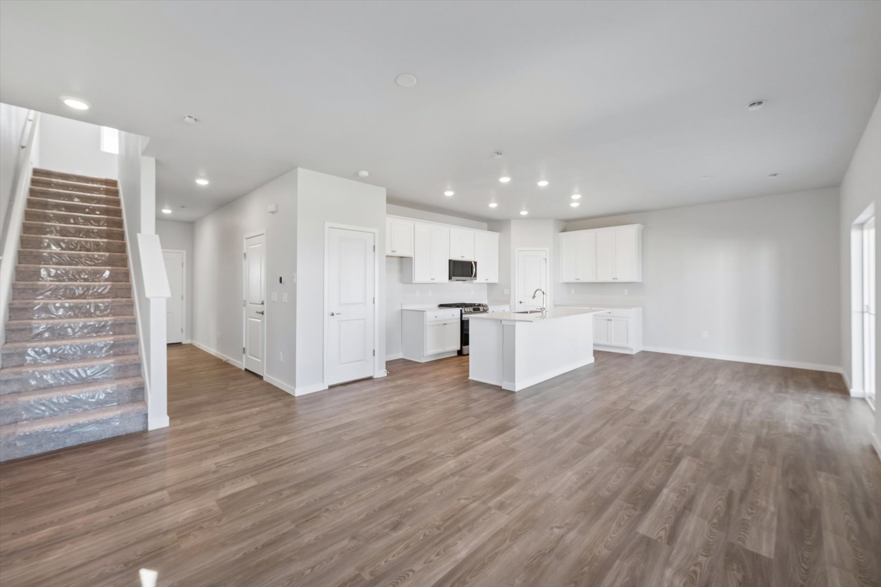 A large kitchen with white cabinets.