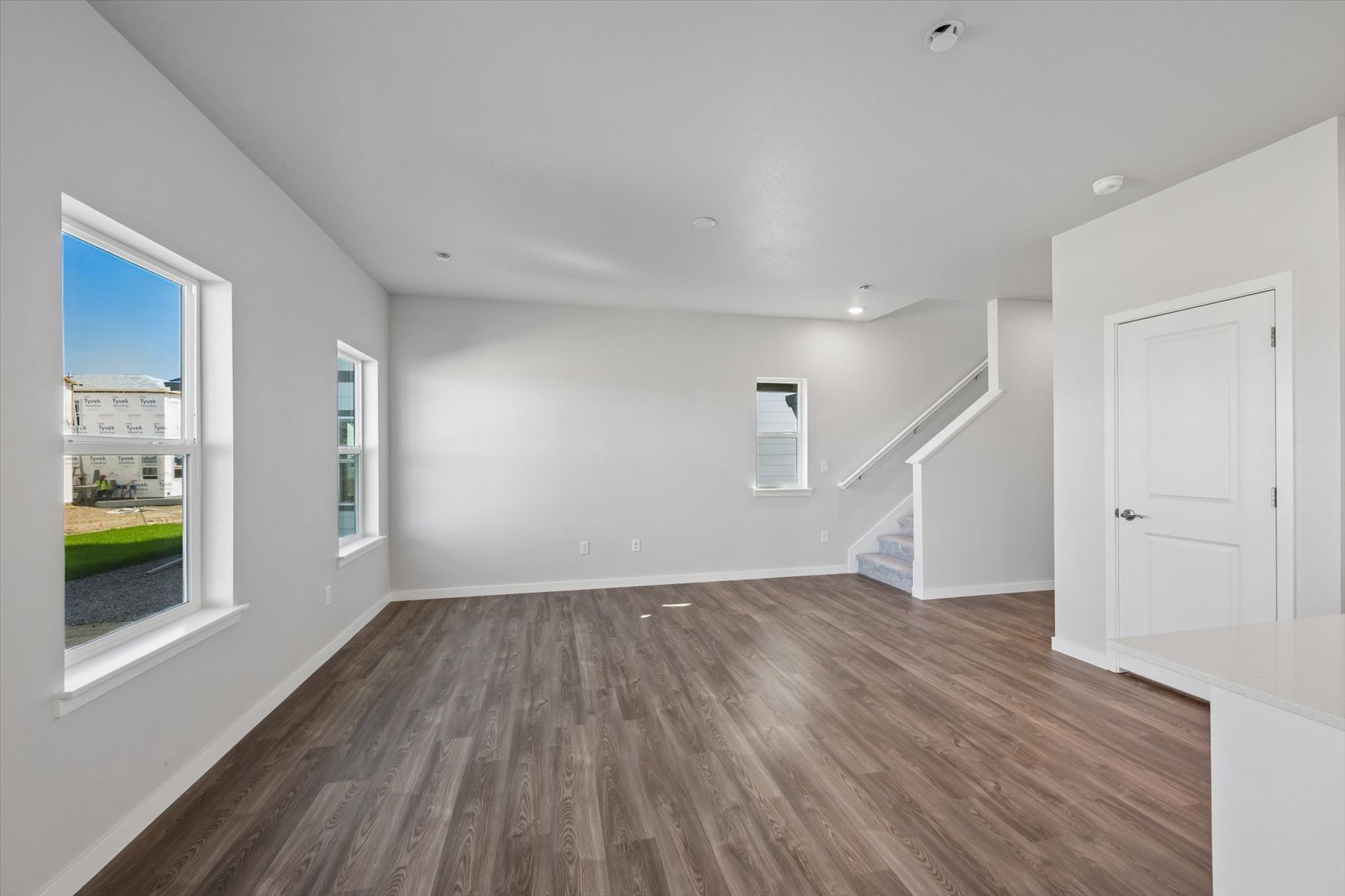 A room with white walls and a wood floor.