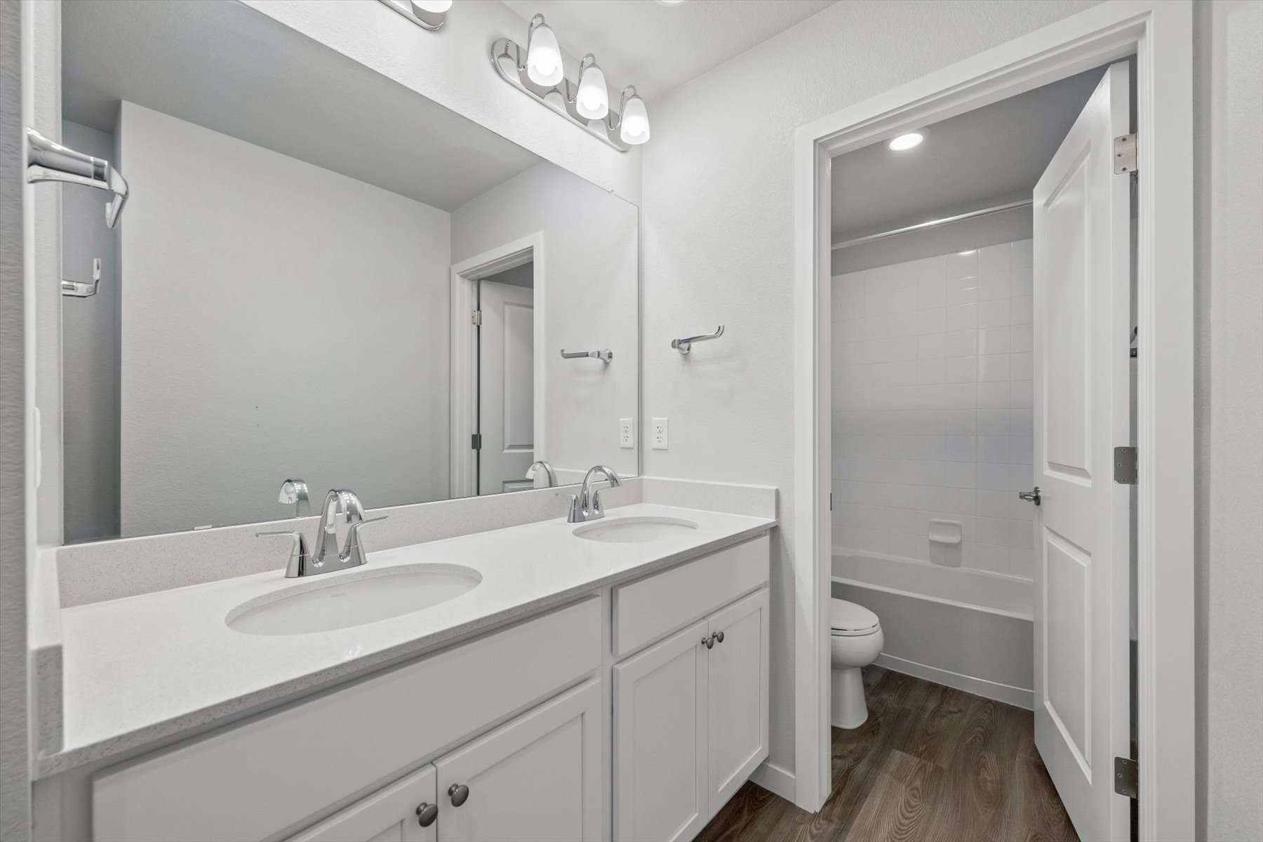 A bathroom with a shower and sink.