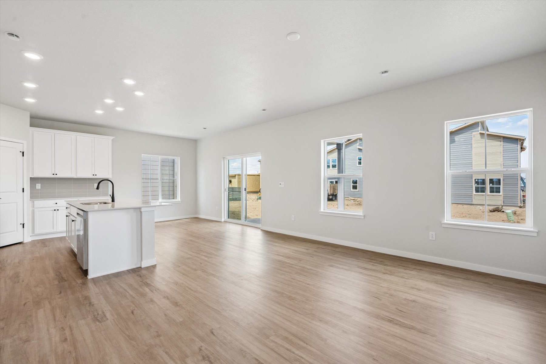 A kitchen with white cabinets.