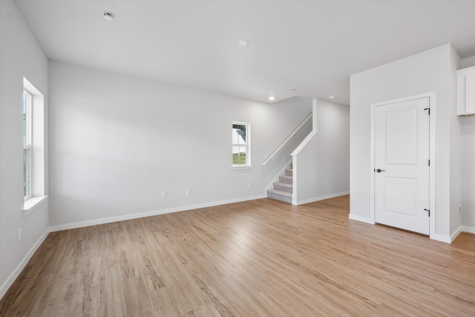 A room with white walls and a wood floor.