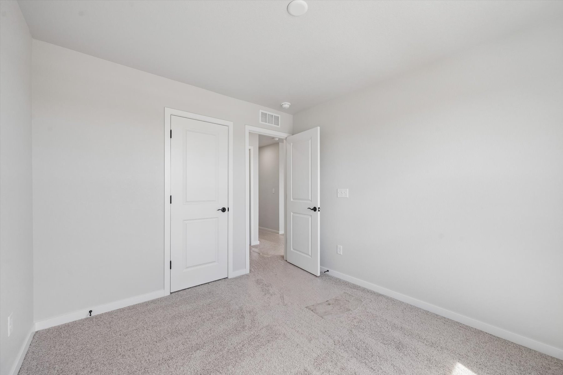 A hallway with white doors.