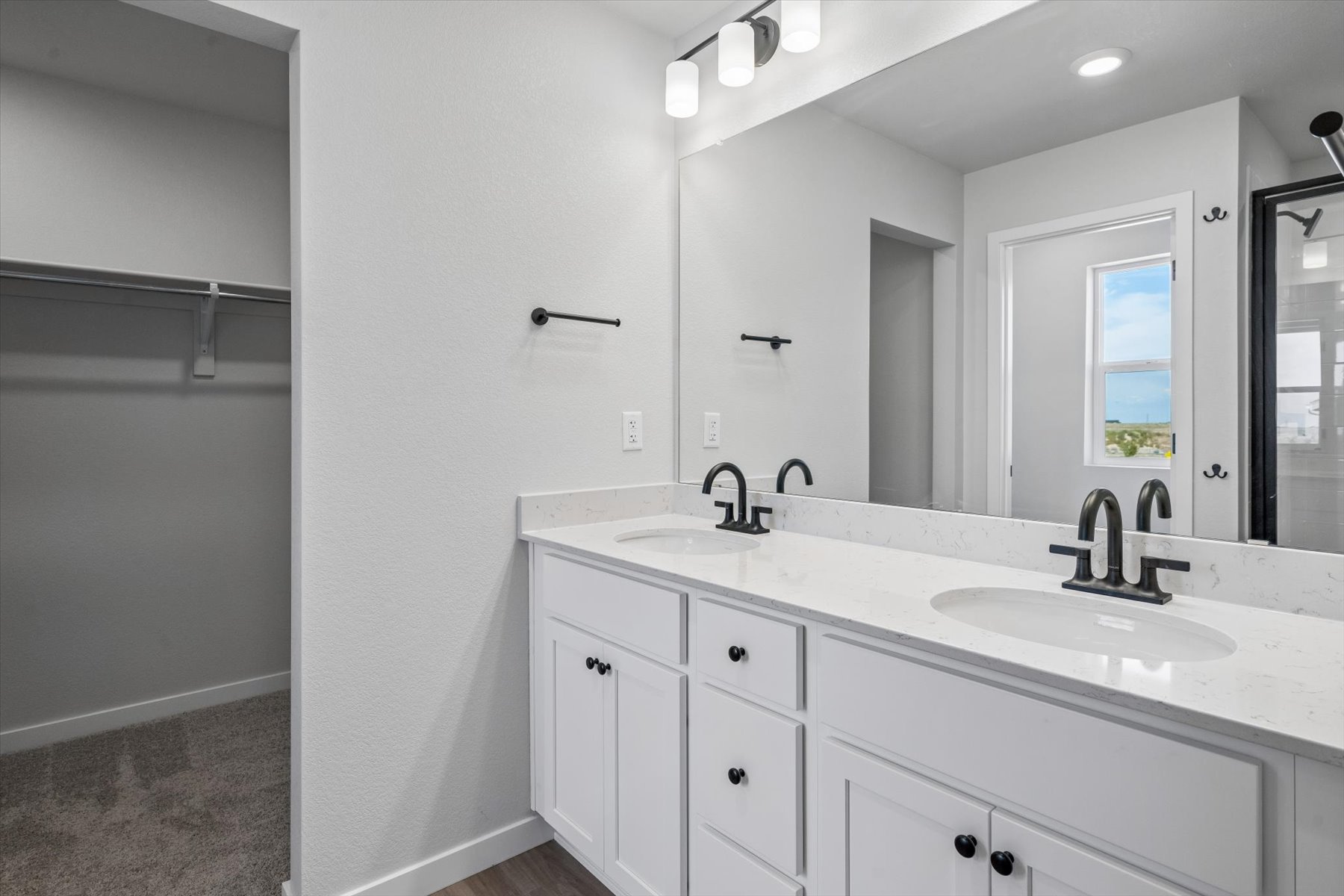 A bathroom with white cabinets.