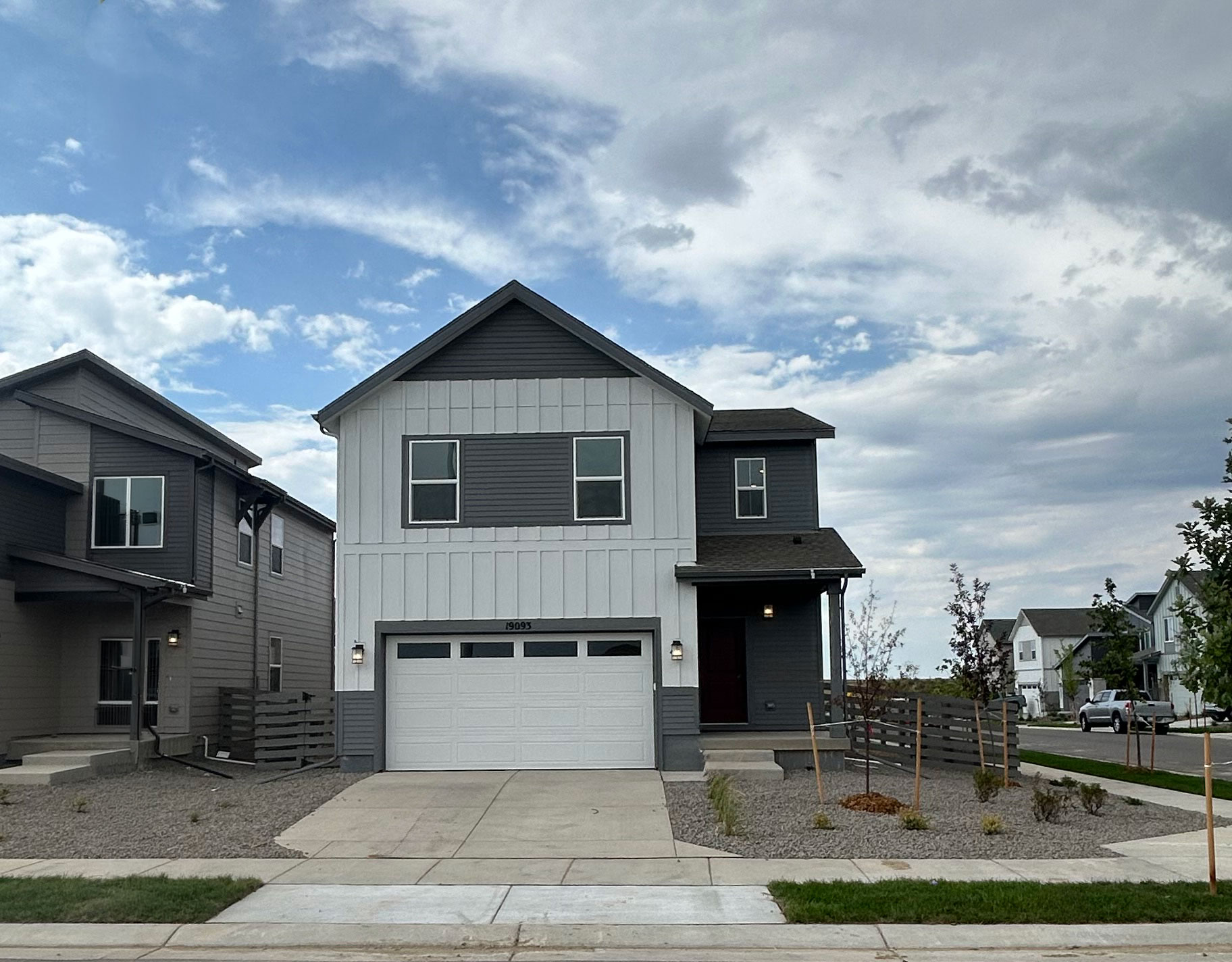 A grey house with a garage.