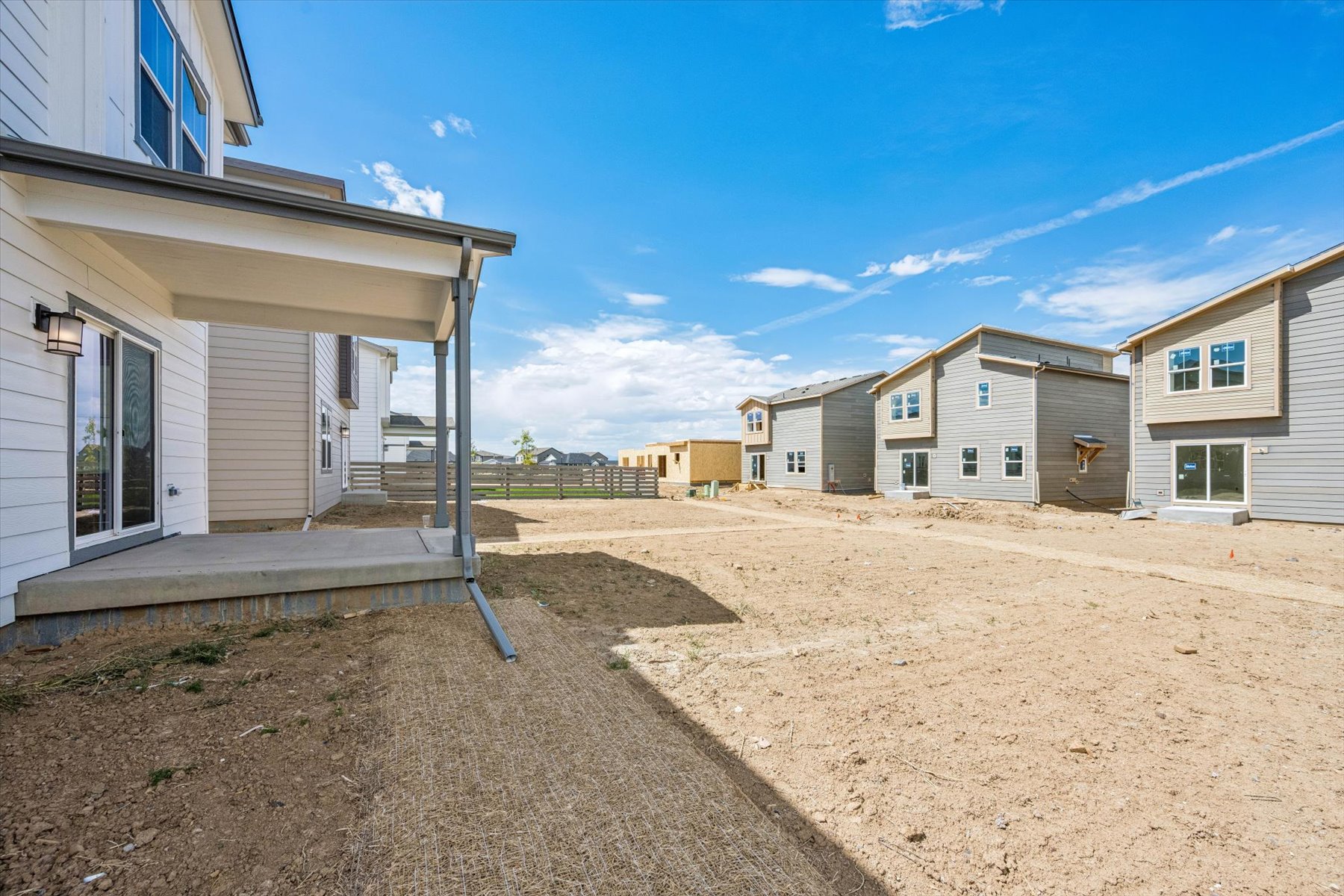 A dirt road between buildings.