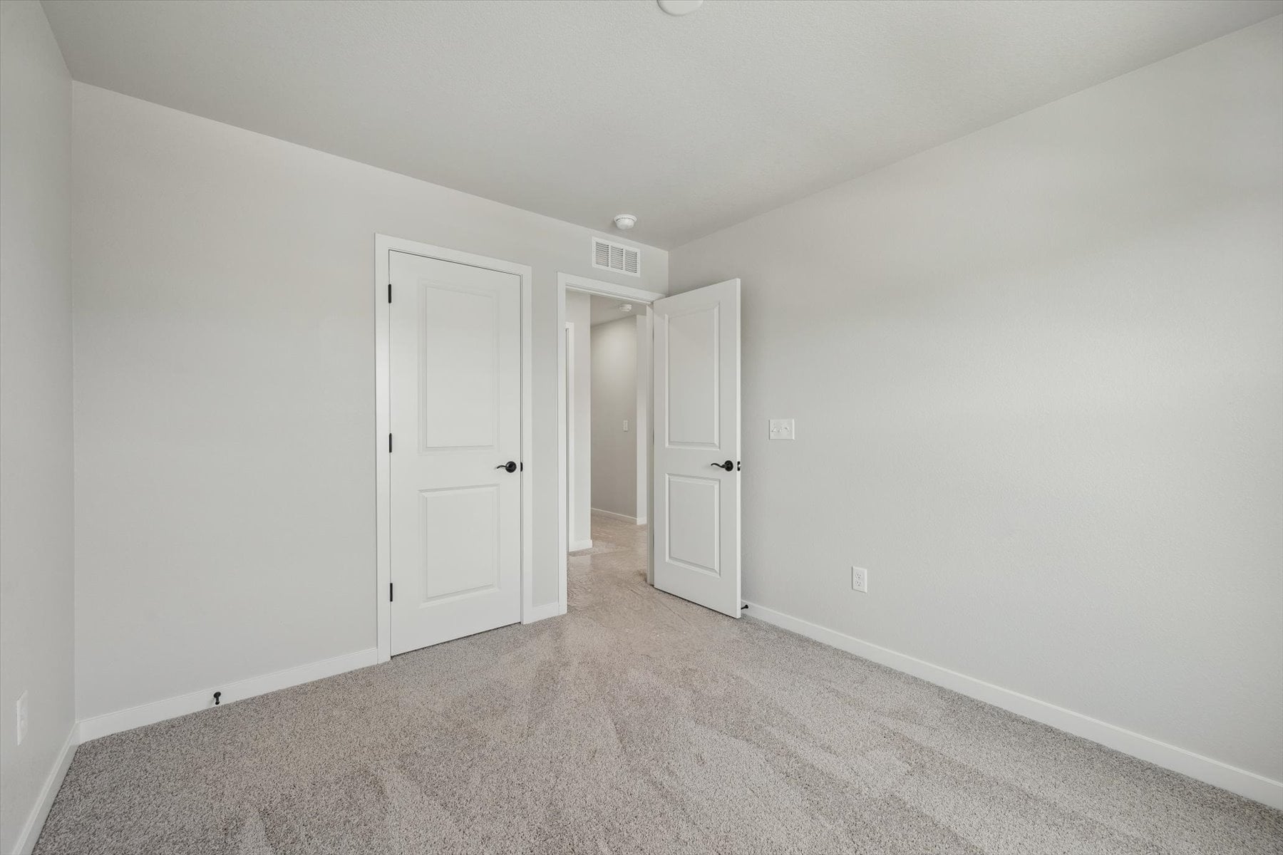 A hallway with white doors.