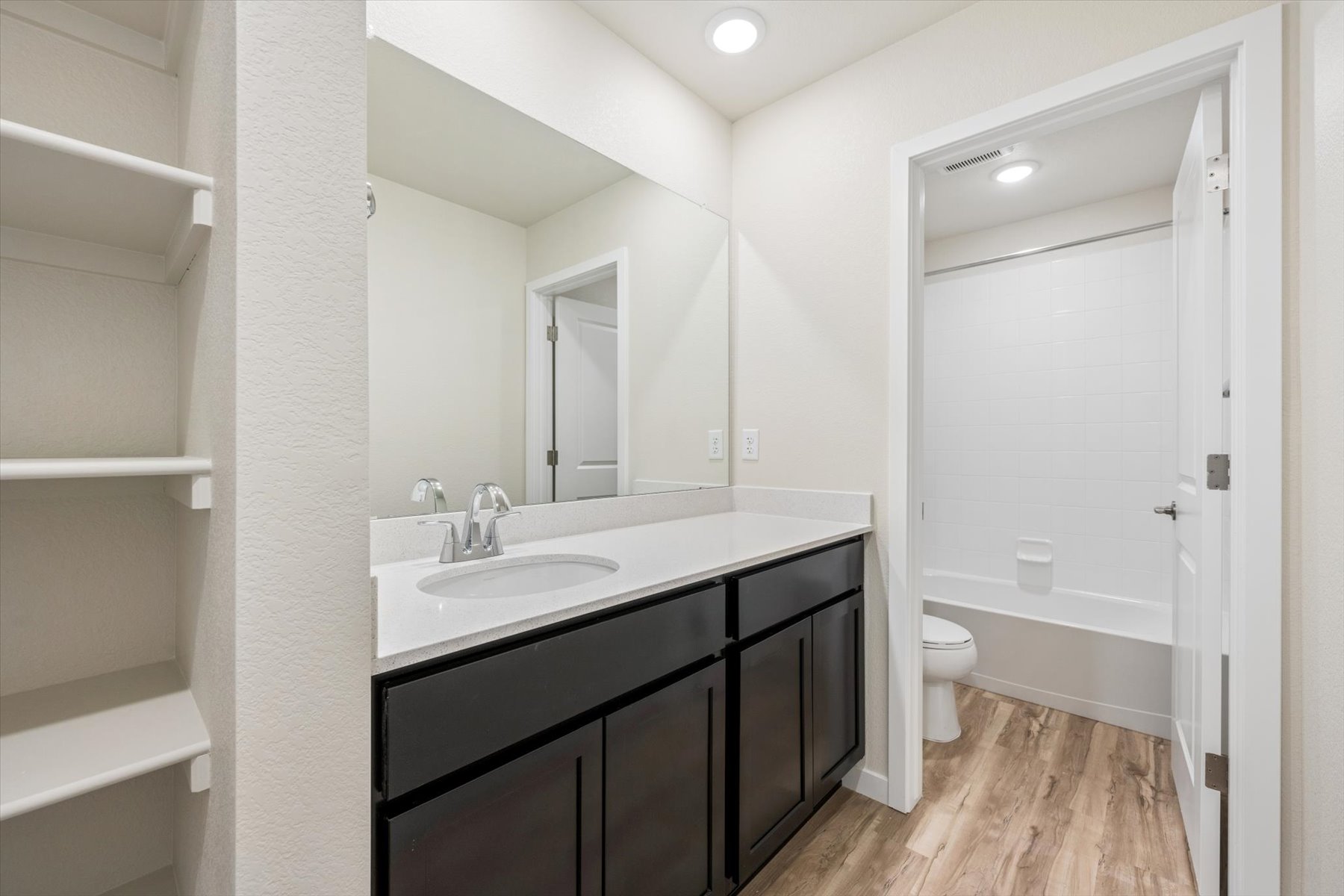 A bathroom with a sink and a toilet.