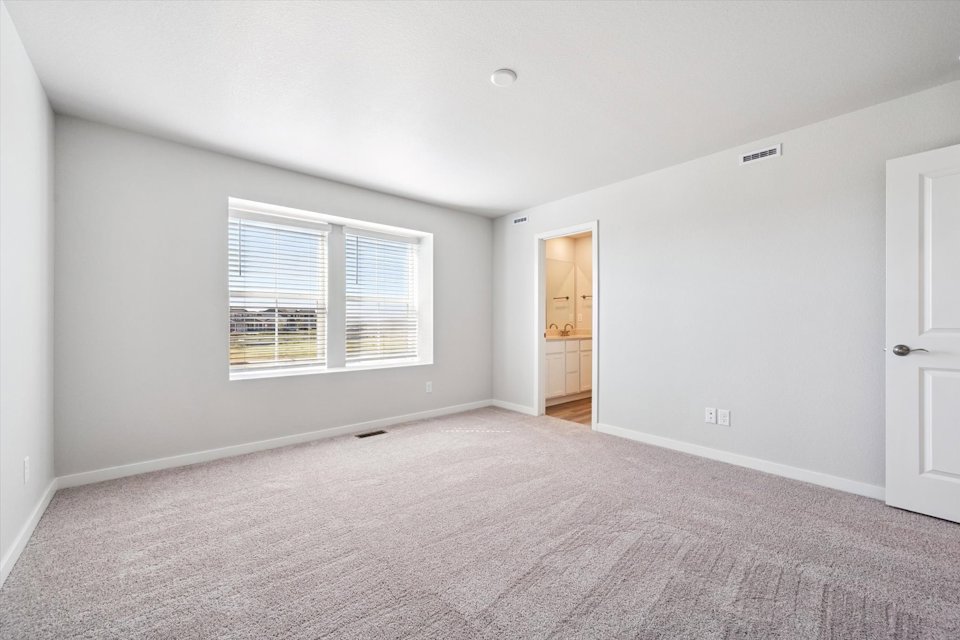 A room with a carpet and a door.