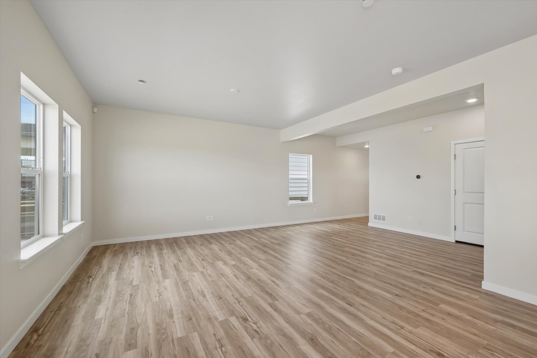 A room with a wood floor and white walls.