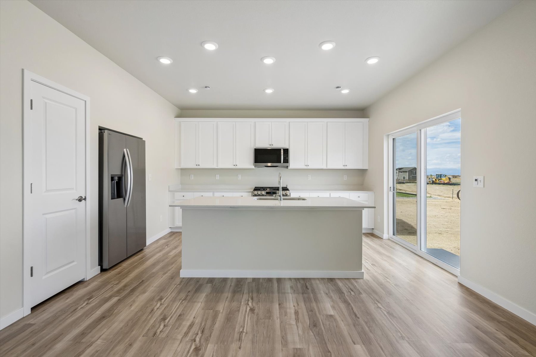 A kitchen with white cabinets.