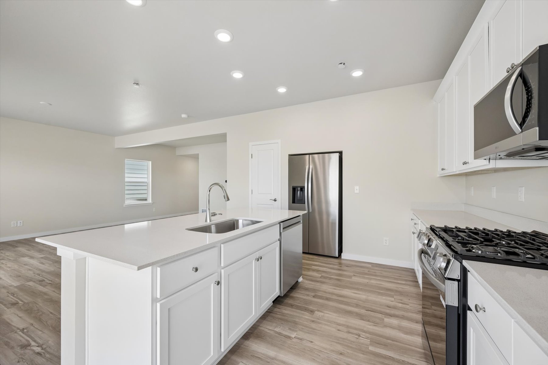 A kitchen with white cabinets.