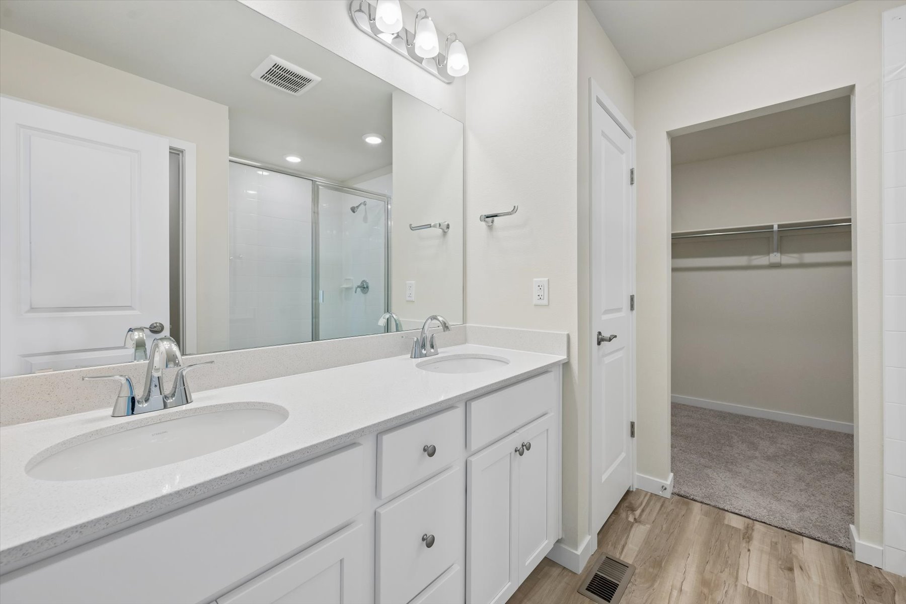 A bathroom with a large mirror.