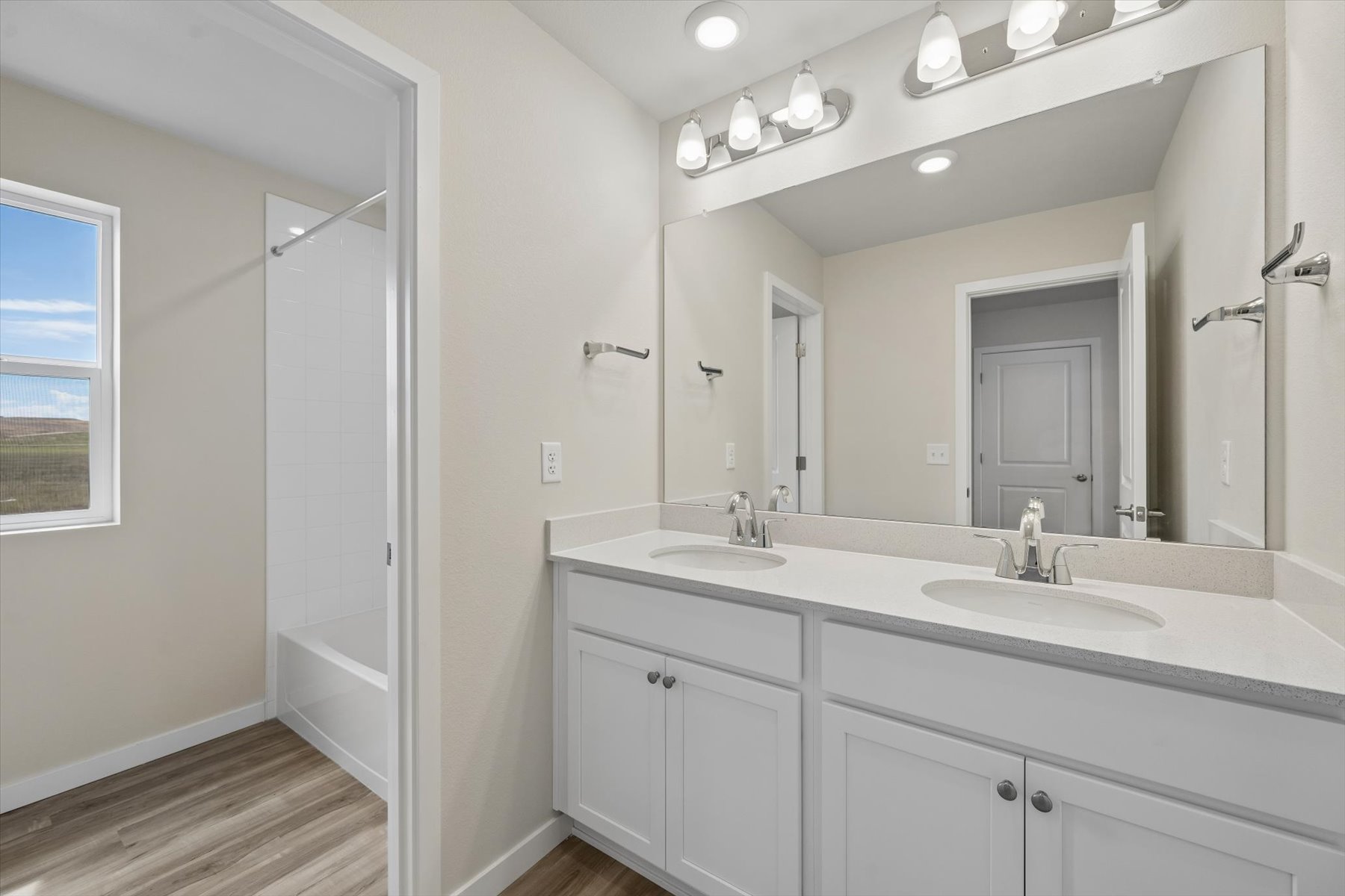 A bathroom with a large mirror.