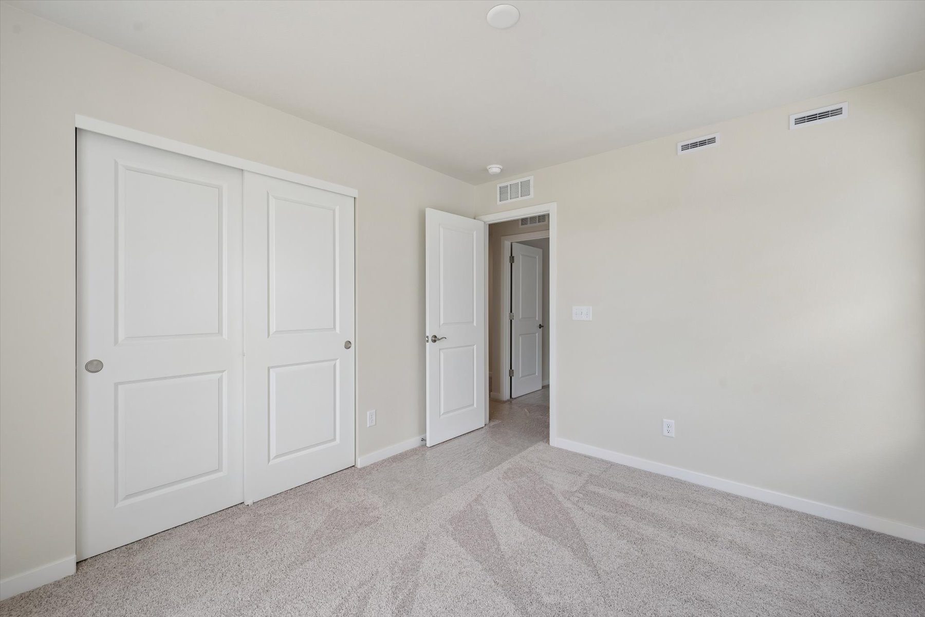 A hallway with white doors.
