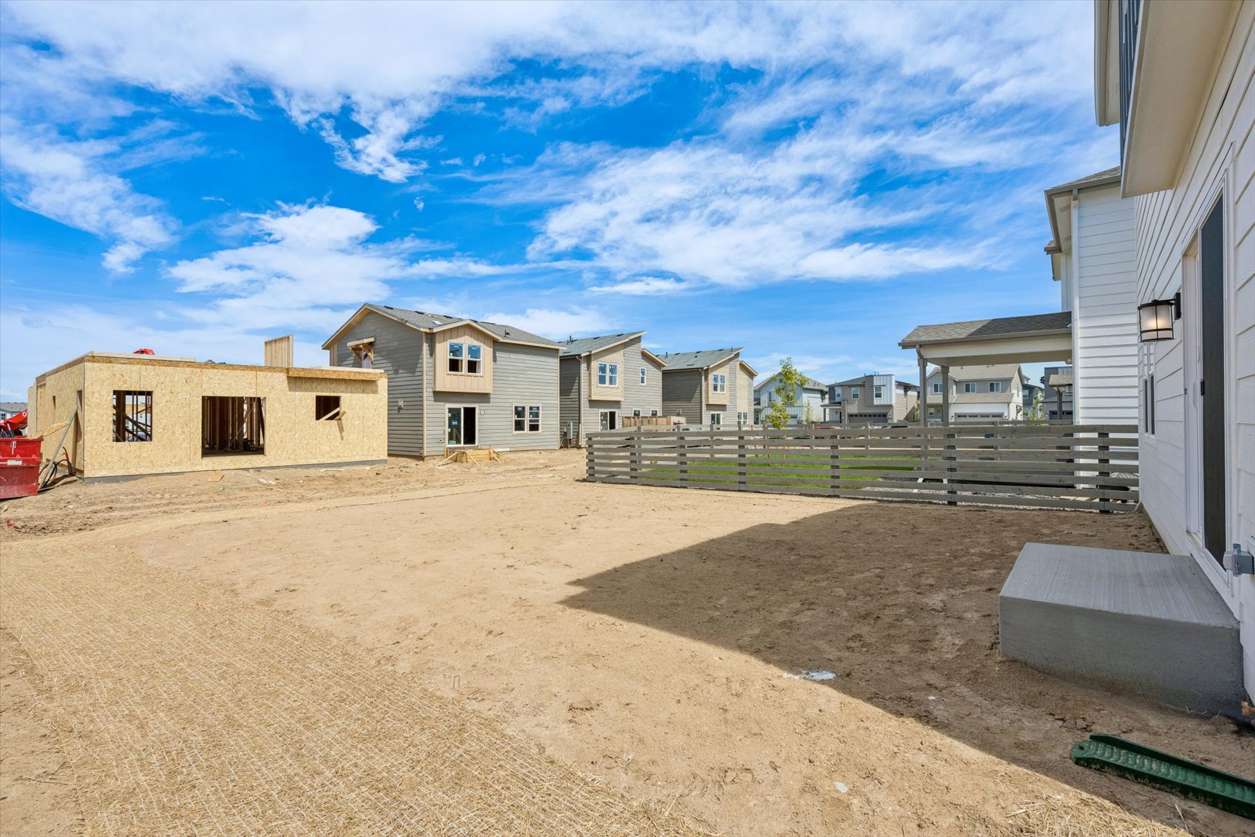 A dirt road between buildings.
