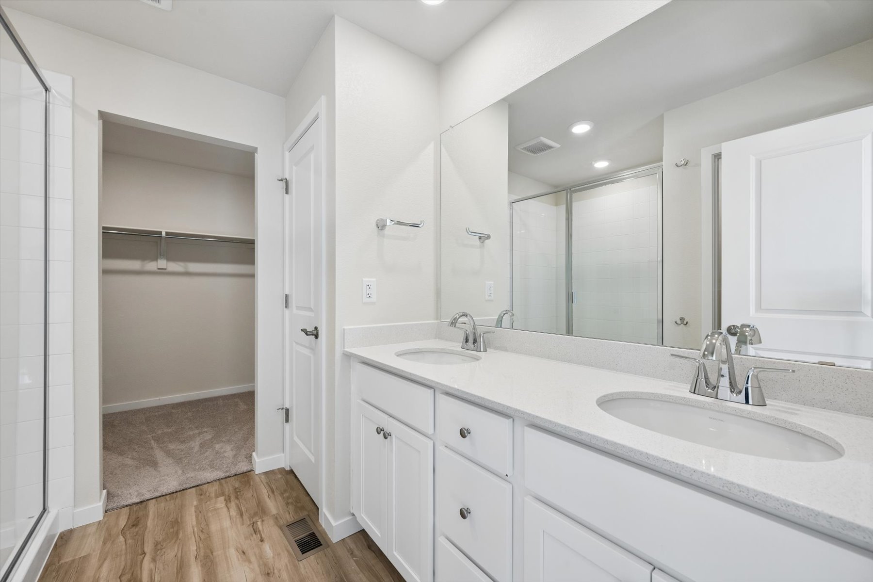 A bathroom with a large mirror.