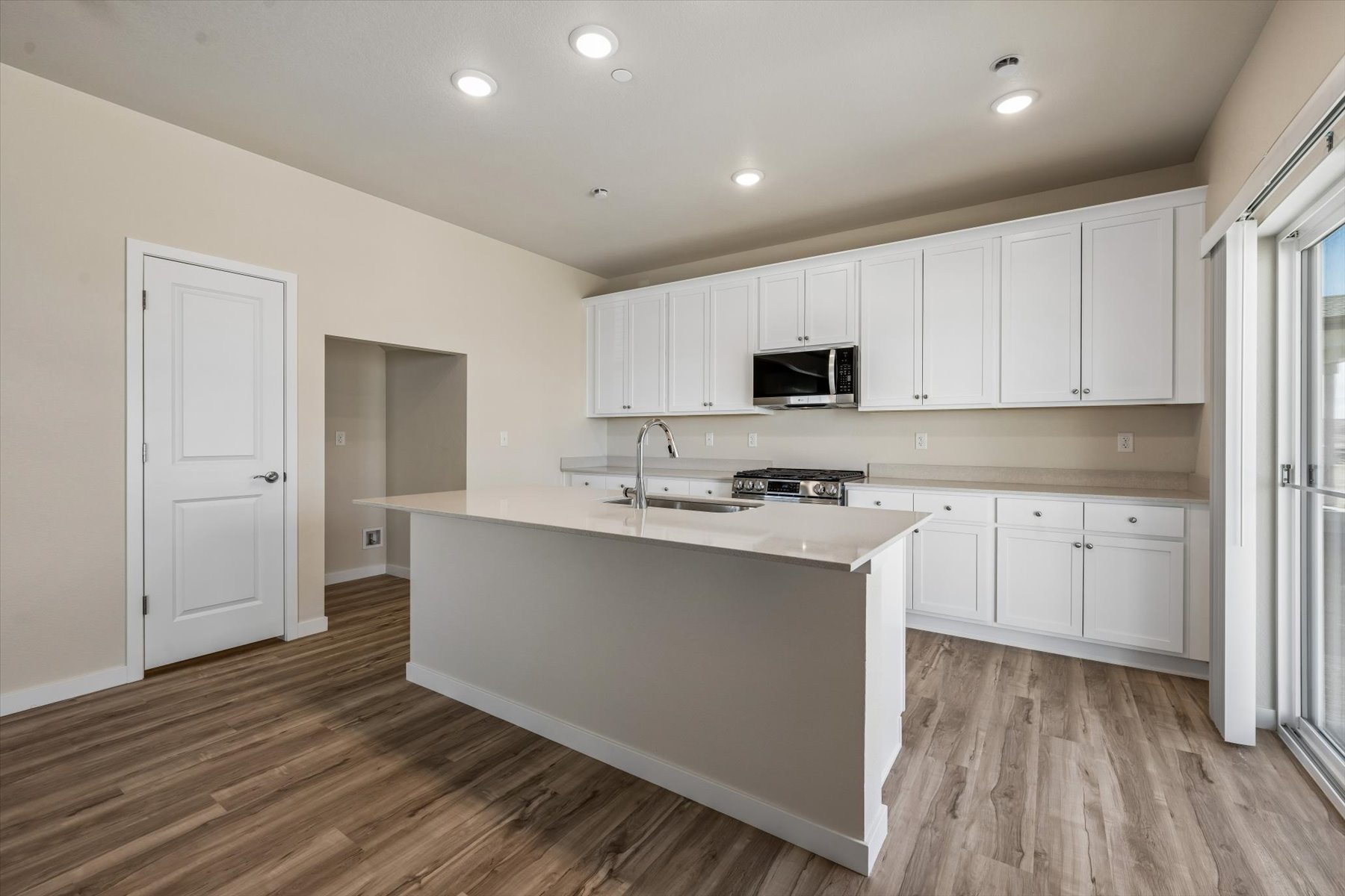 A kitchen with white cabinets.