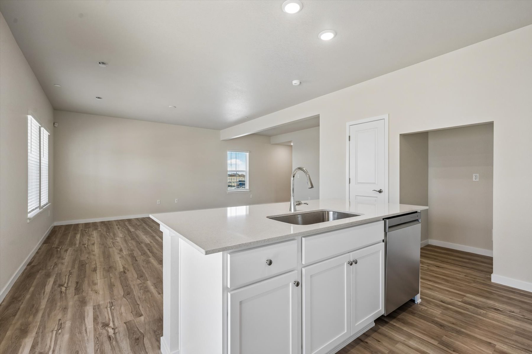 A kitchen with white cabinets.