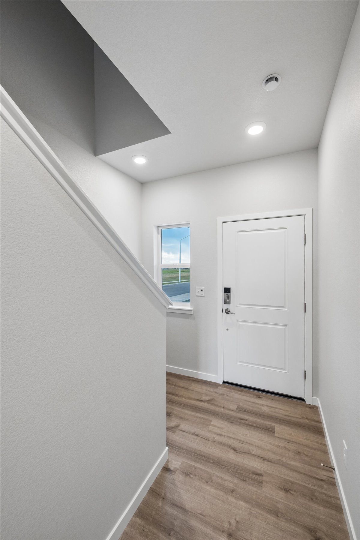 A room with white walls and a wood floor.