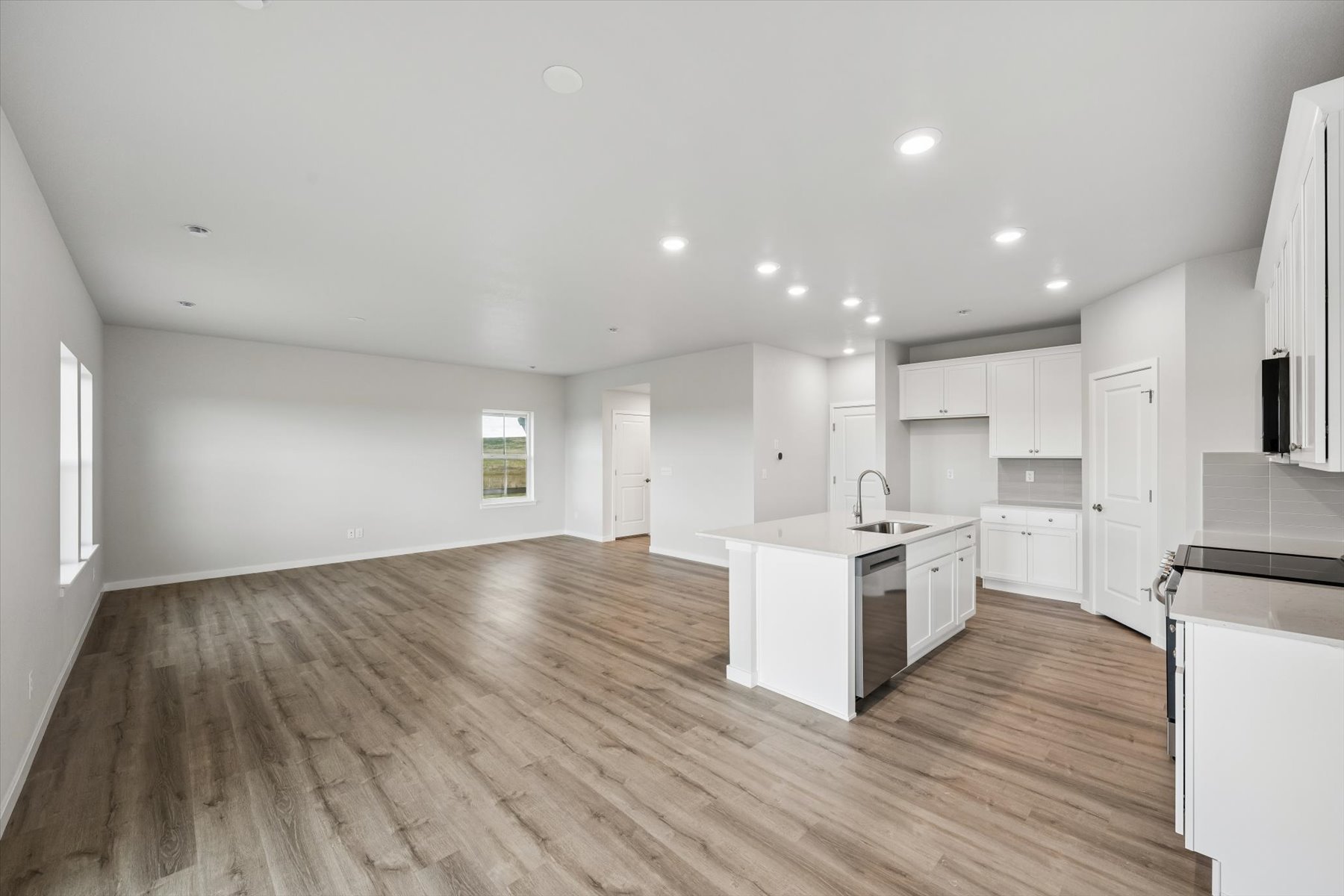 A large kitchen with white cabinets.