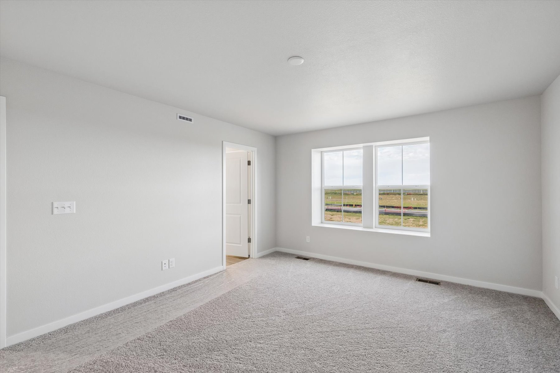 A room with a door and windows.